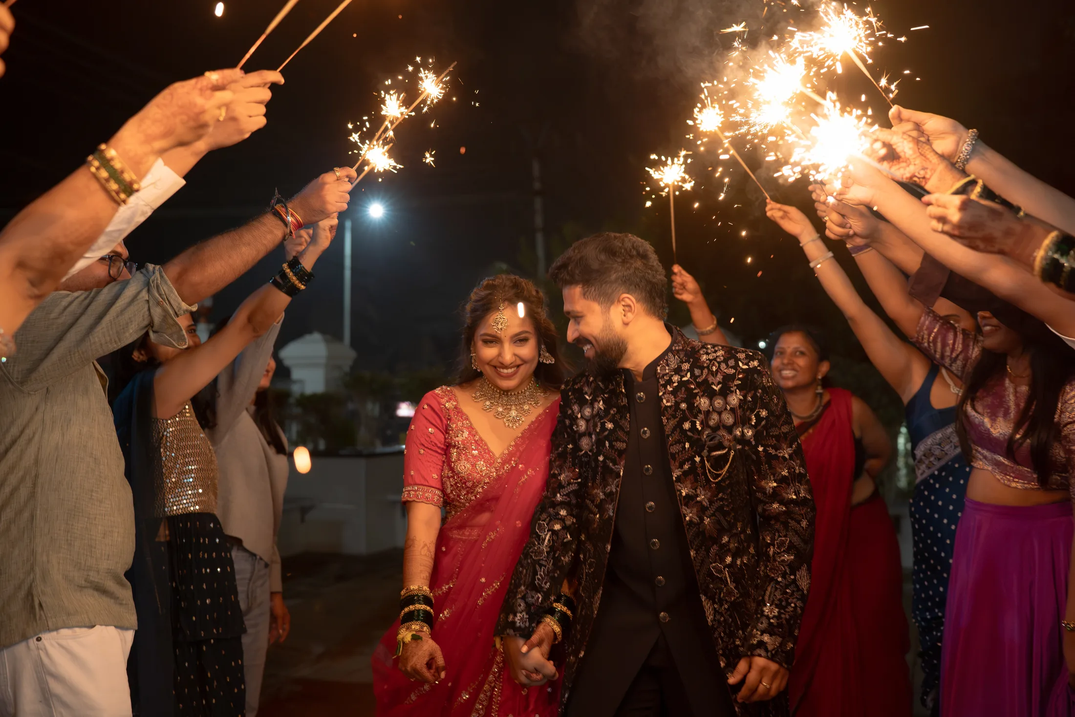 Couple arriving beneath sparklers