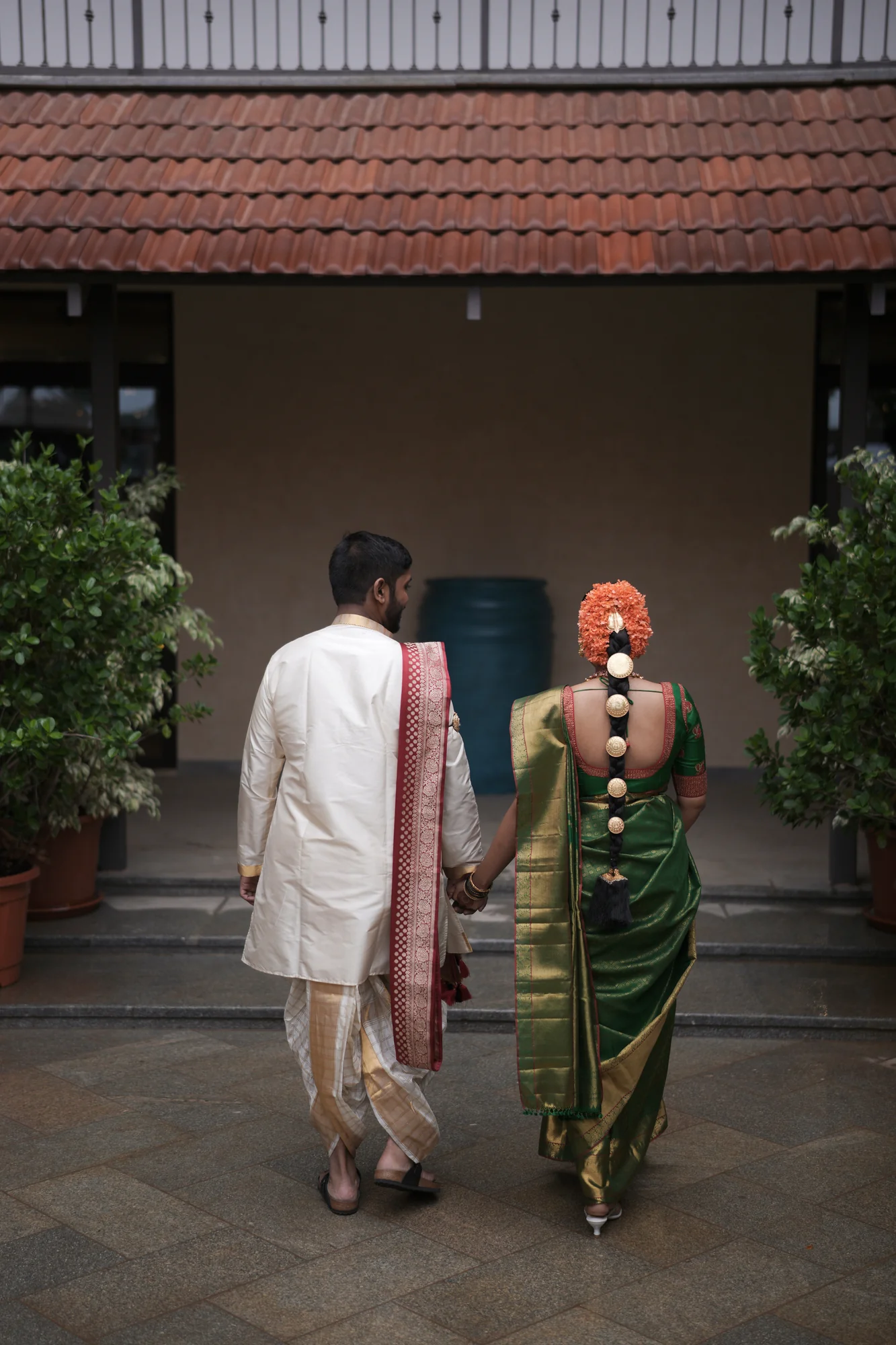 A couple walking together through a courtyard