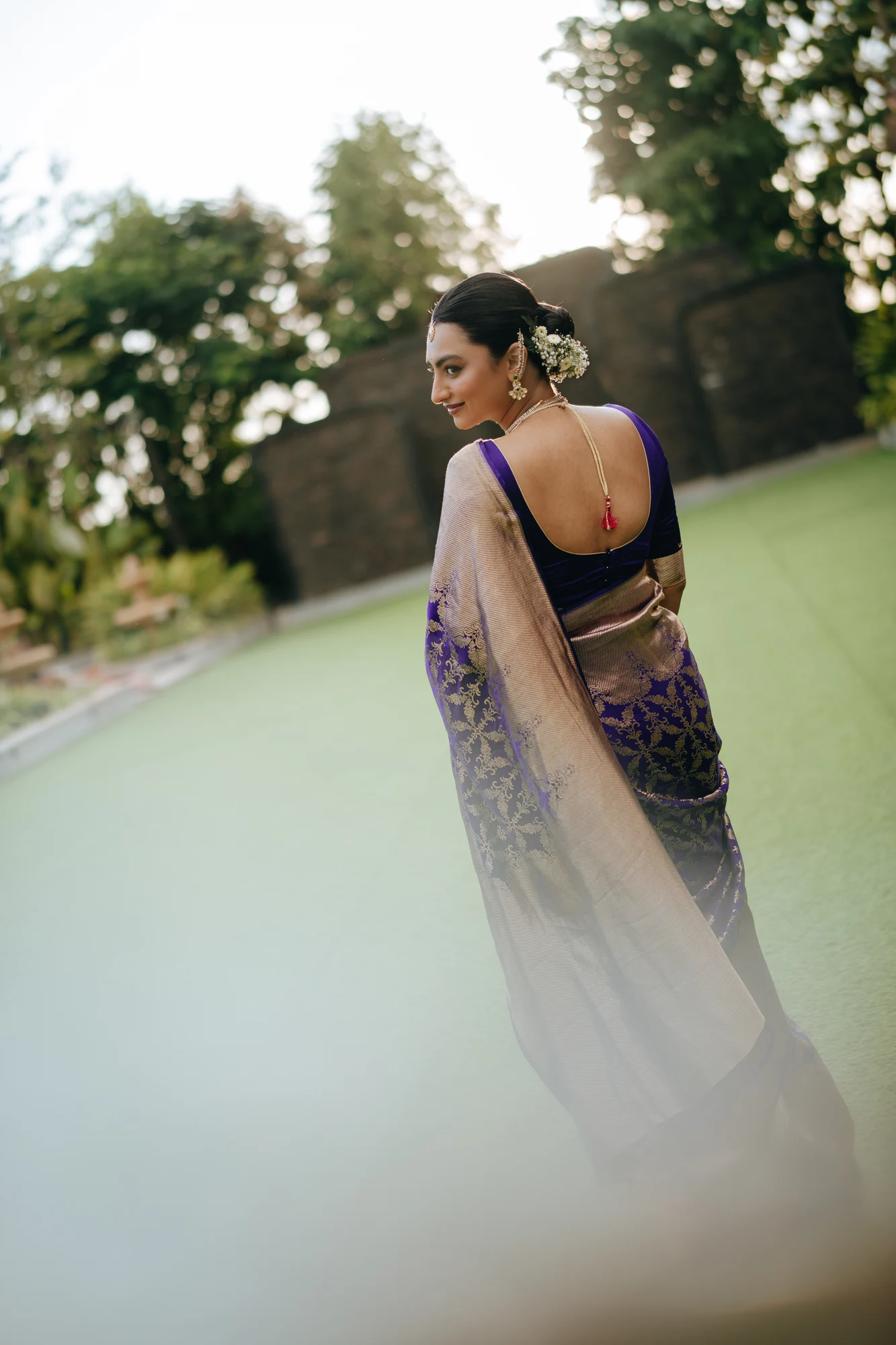 A bride framed by soft light in a garden