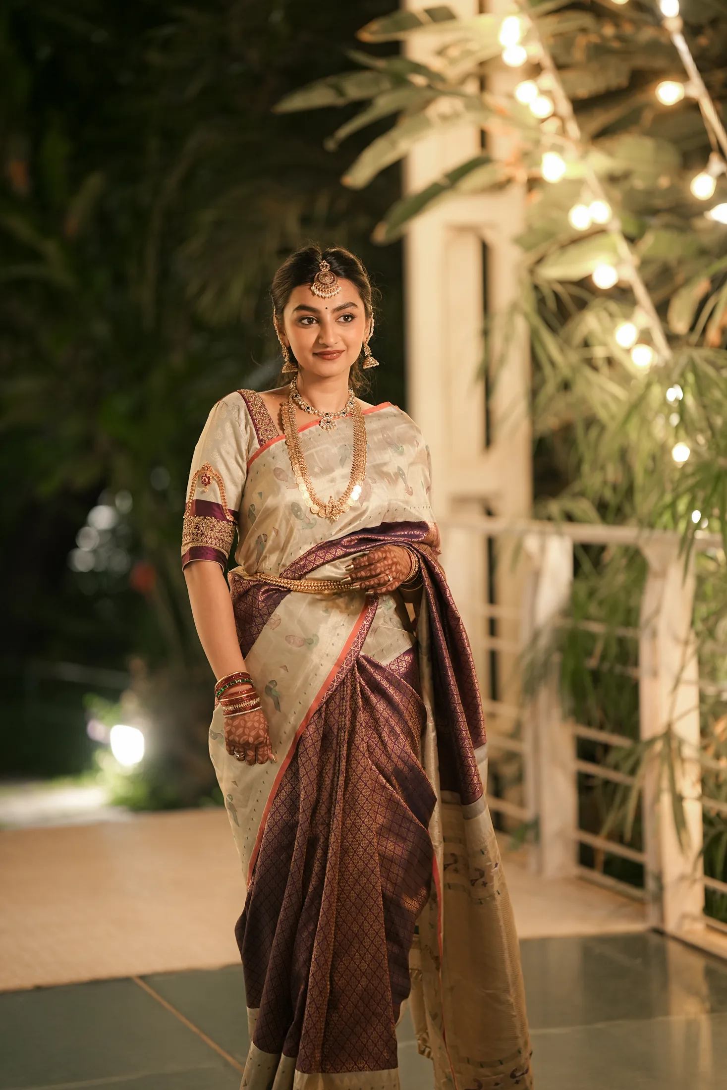 Bride standing beneath warm evening lights